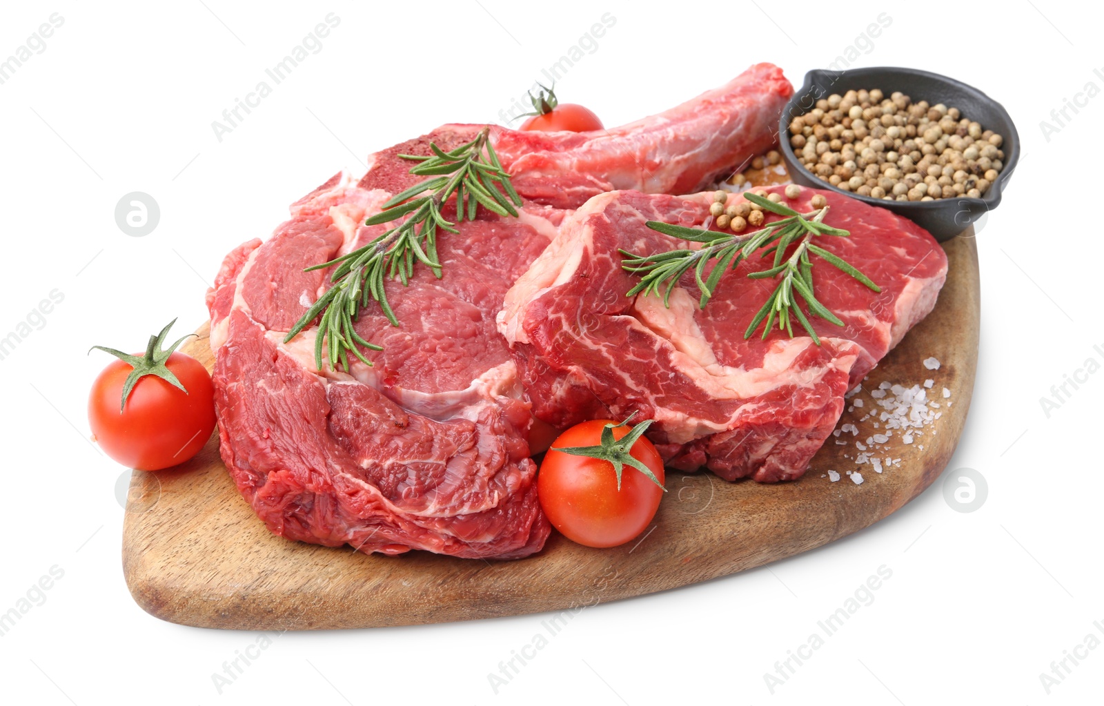 Photo of Pieces of raw beef meat, spices and tomatoes isolated on white