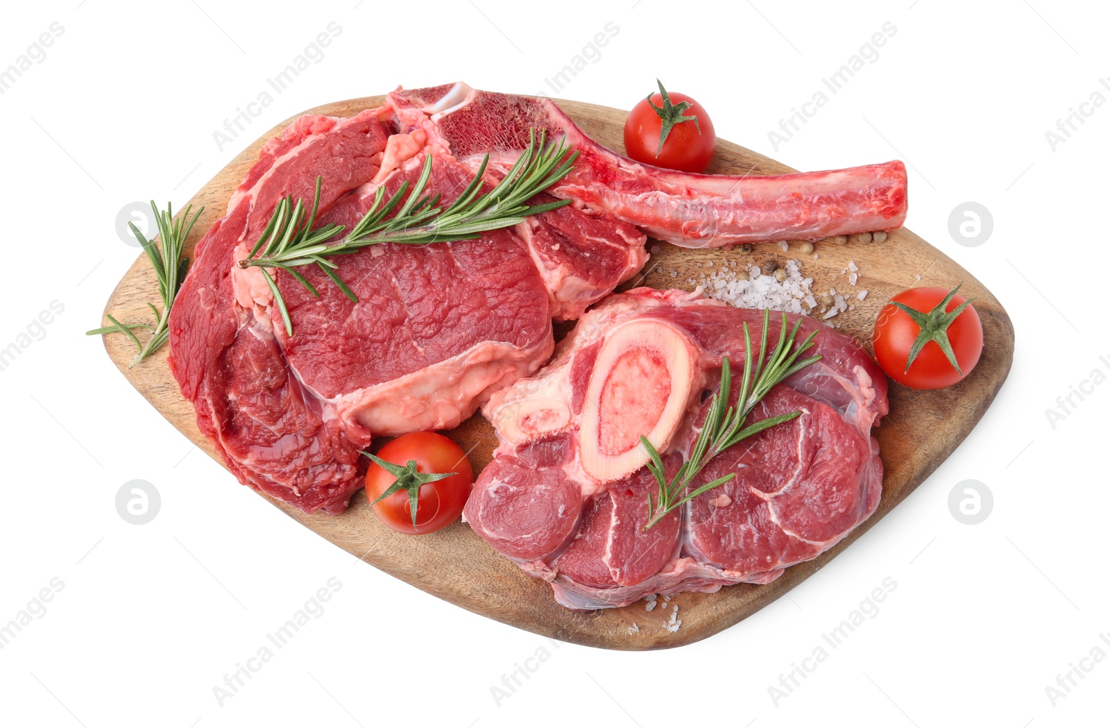 Photo of Pieces of raw beef meat, spices and tomatoes isolated on white