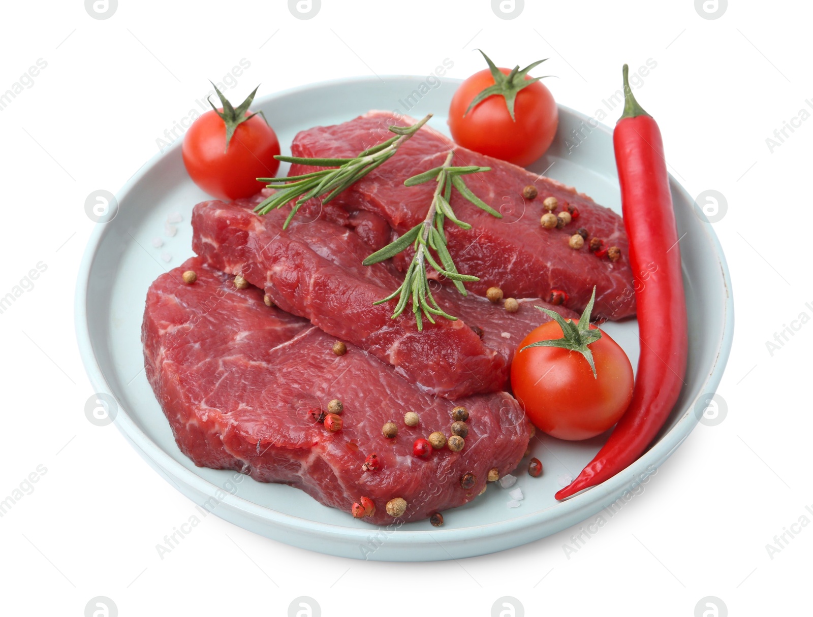 Photo of Pieces of raw beef meat, spices and tomatoes isolated on white