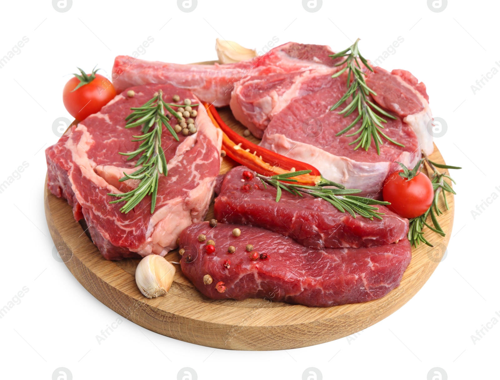 Photo of Pieces of raw beef meat, spices and tomatoes isolated on white