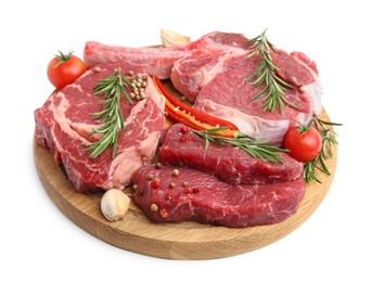 Photo of Pieces of raw beef meat, spices and tomatoes isolated on white