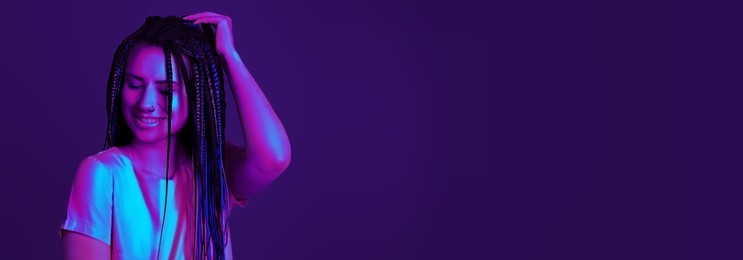 Image of Beautiful young woman with nose piercing and dreadlocks in neon light, space for text. Banner design