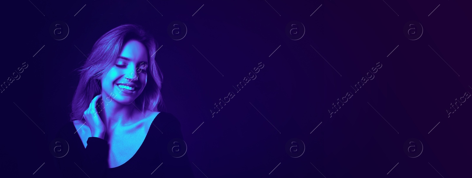 Image of Happy young woman in neon light, space for text. Banner design