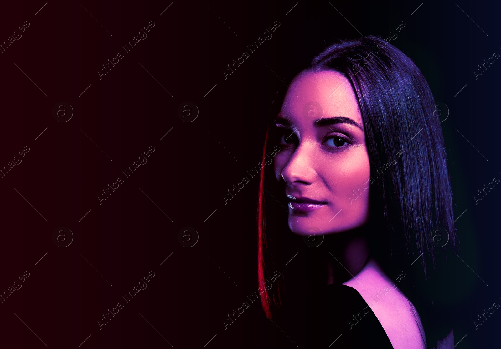 Image of Attractive young woman in neon light, space for text