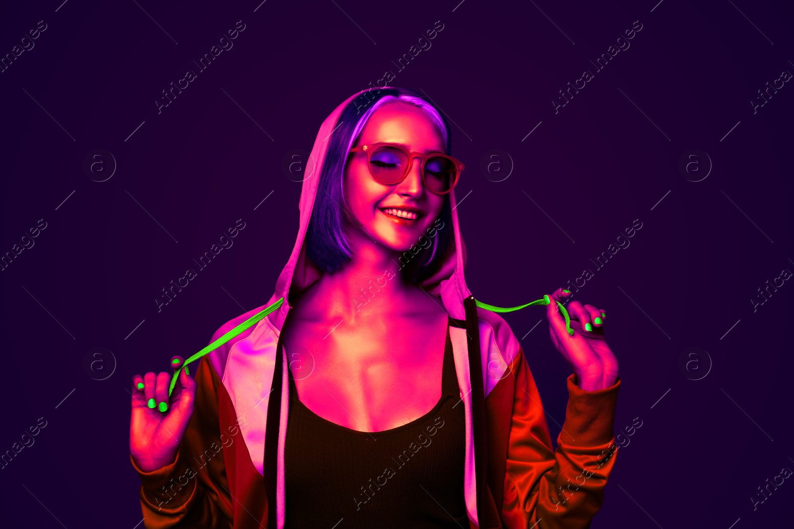 Image of Beautiful young woman with bright dyed hair in neon light