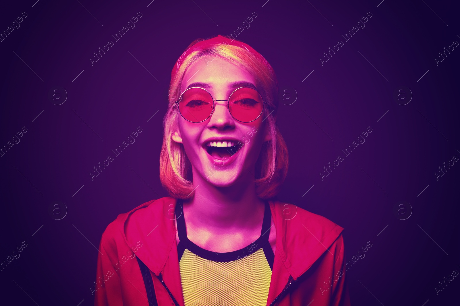 Image of Beautiful young woman with bright dyed hair in neon light