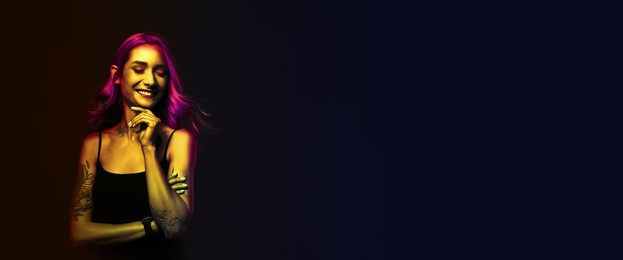 Image of Beautiful woman with tattoos on body in neon light, space for text. Banner design