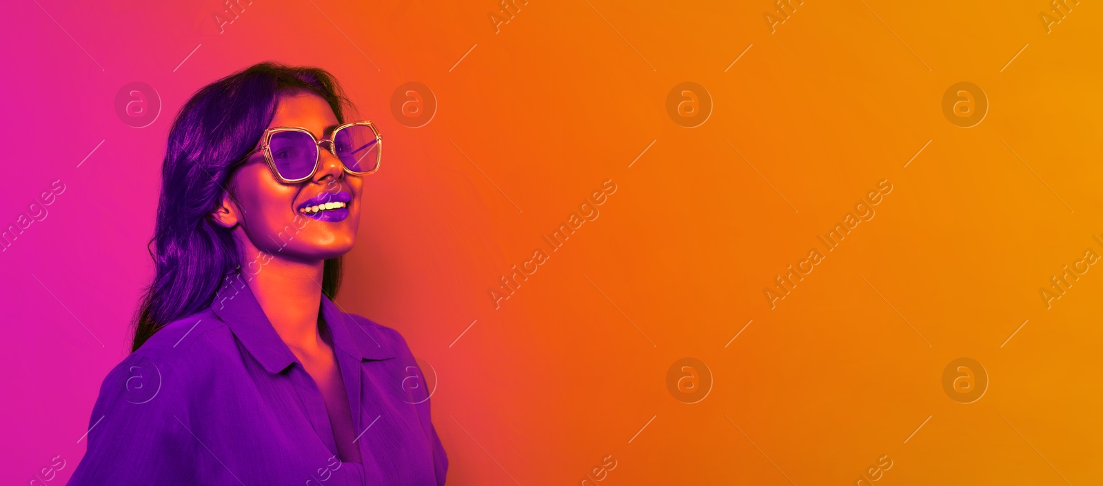 Image of Happy beautiful woman with stylish sunglasses in neon light, space for text. Banner design