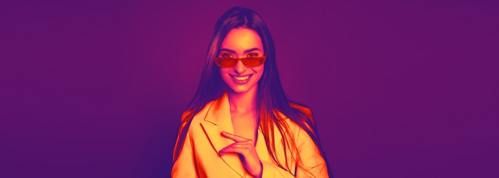 Image of Stylish woman with sunglasses in neon light. Banner design