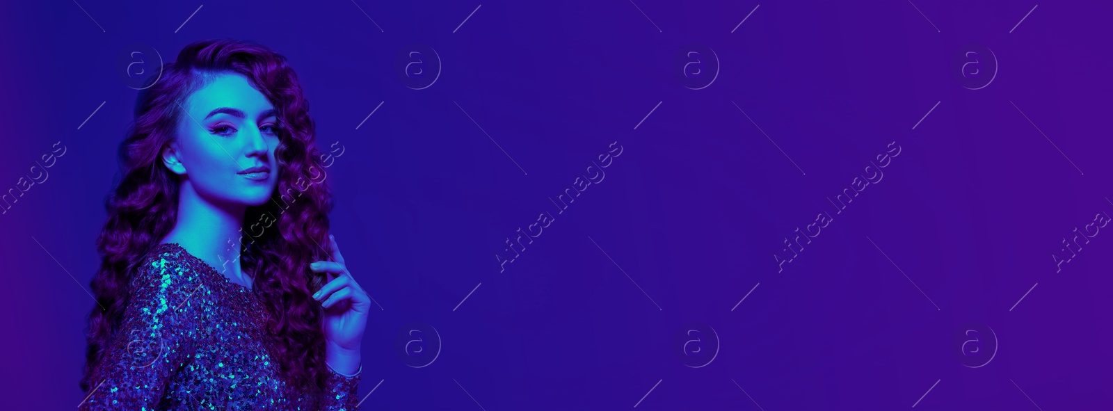 Image of Beautiful young woman with curly hair in neon light, space for text. Banner design