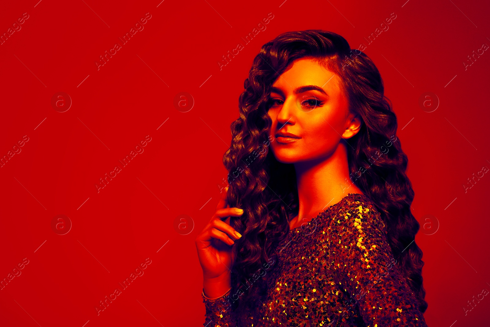 Image of Beautiful young woman with curly hair in neon light, space for text