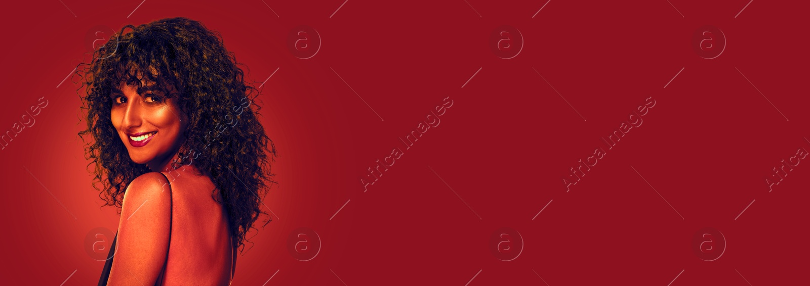 Image of Beautiful young woman with curly hair in neon light, space for text. Banner design