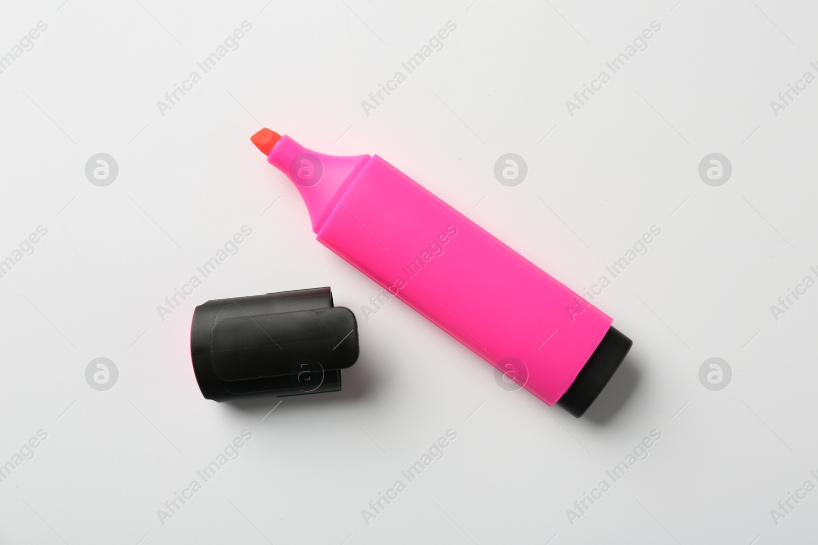 Photo of Bright highlighter and cap on white background, flat lay