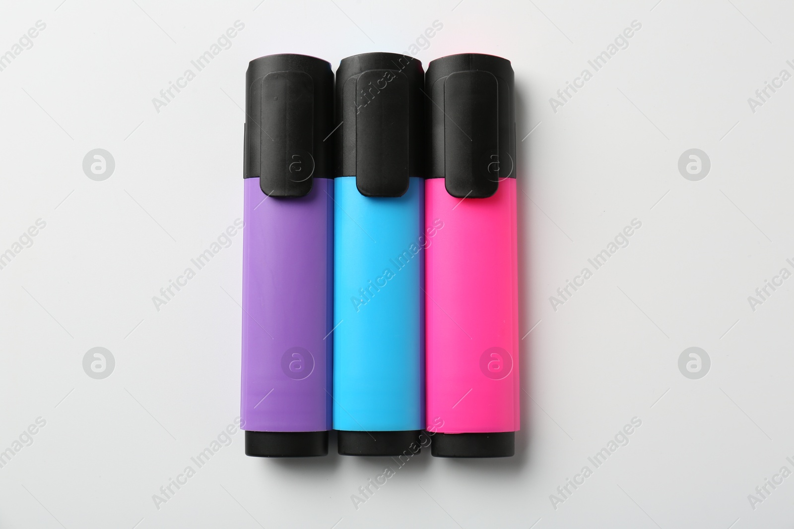 Photo of Bright highlighters on white background, flat lay. Space for text