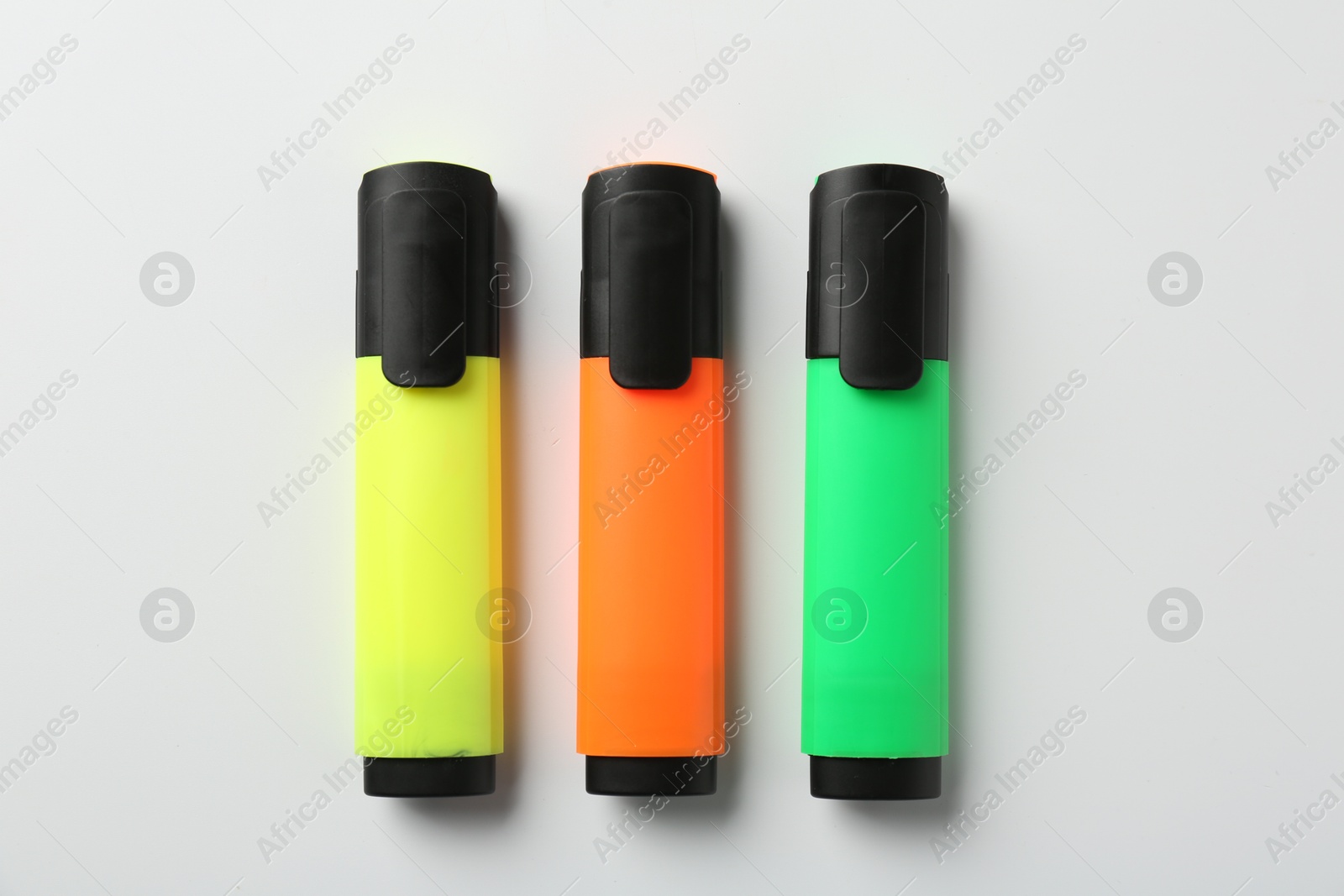 Photo of Bright highlighters on white background, flat lay. Space for text