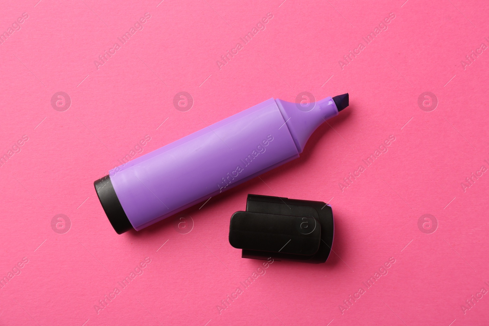 Photo of Bright highlighter and cap on pink background, flat lay