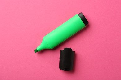 Photo of Bright highlighter and cap on pink background, flat lay