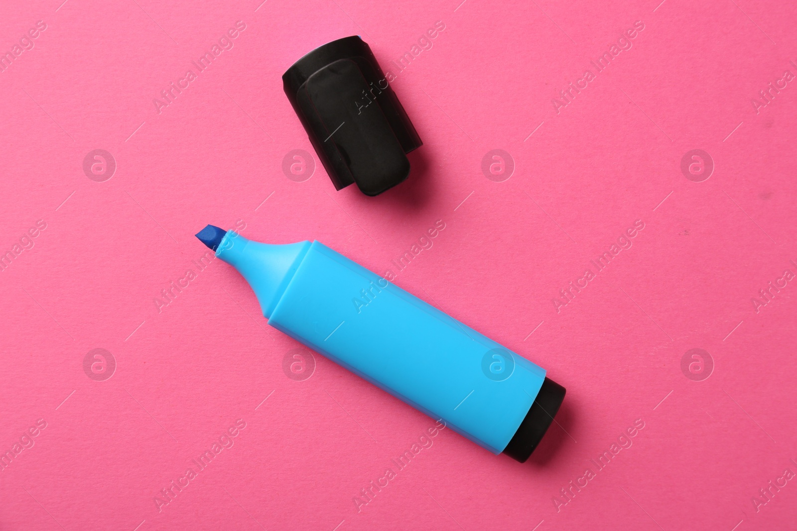 Photo of Bright highlighter and cap on pink background, flat lay