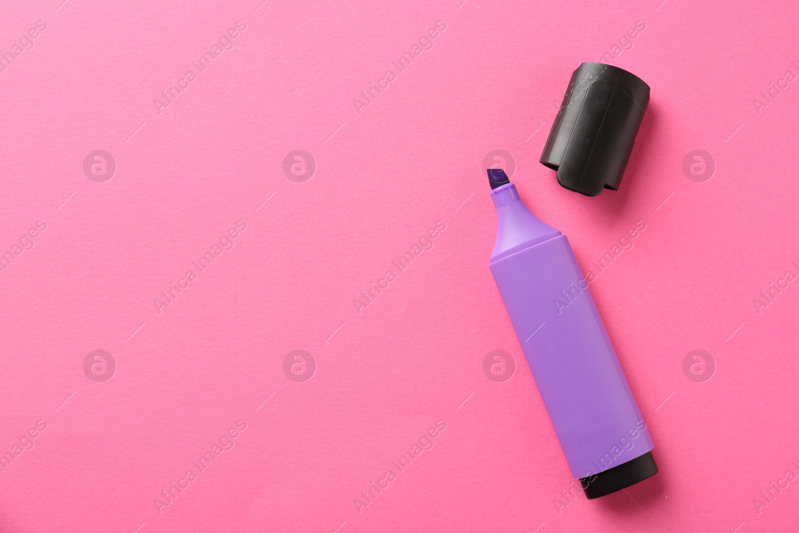 Photo of Bright highlighter and cap on pink background, flat lay. Space for text