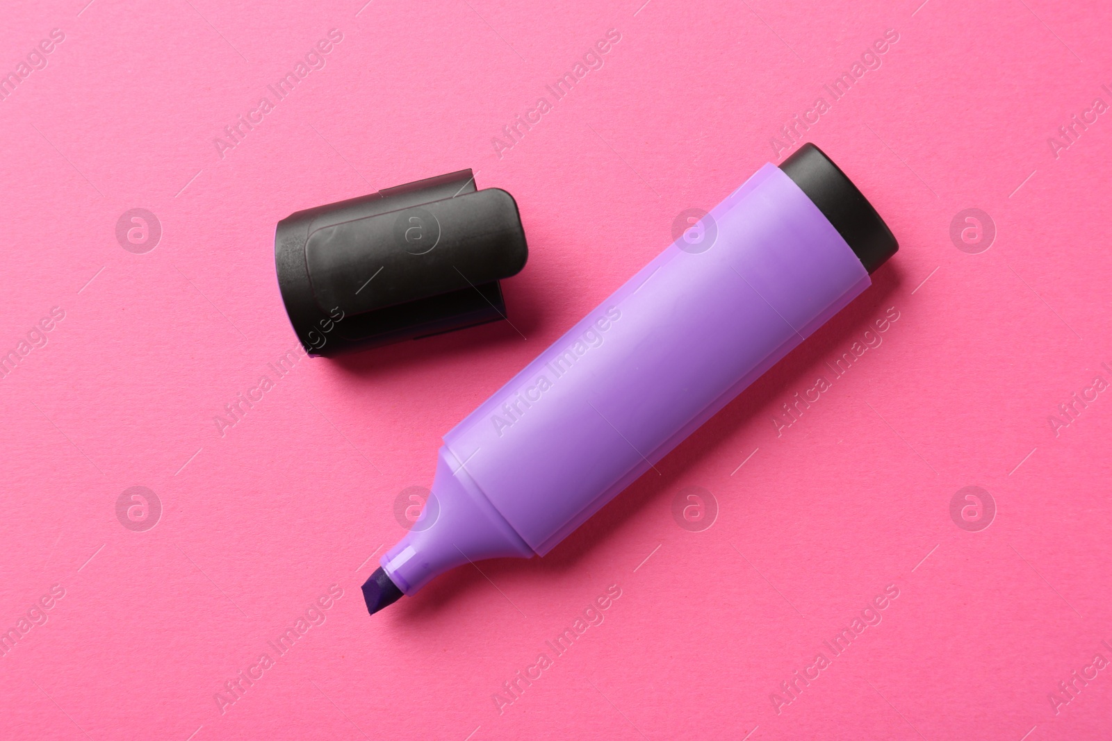 Photo of Bright highlighter and cap on pink background, flat lay