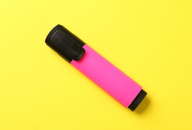 Photo of Bright highlighter on yellow background, top view