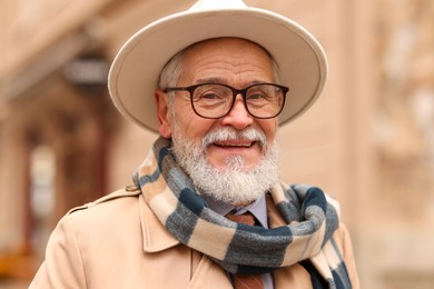 Photo of Portrait of elegant senior man in hat outdoors