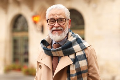 Photo of Stylish bearded senior man on city street