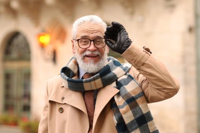 Photo of Stylish bearded senior man on city street