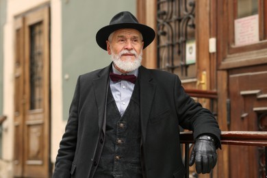 Photo of Elegant bearded senior man on city street