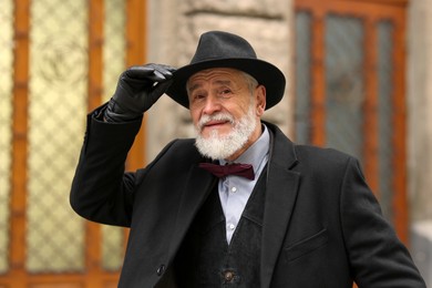 Photo of Bearded senior man in elegant outfit outdoors