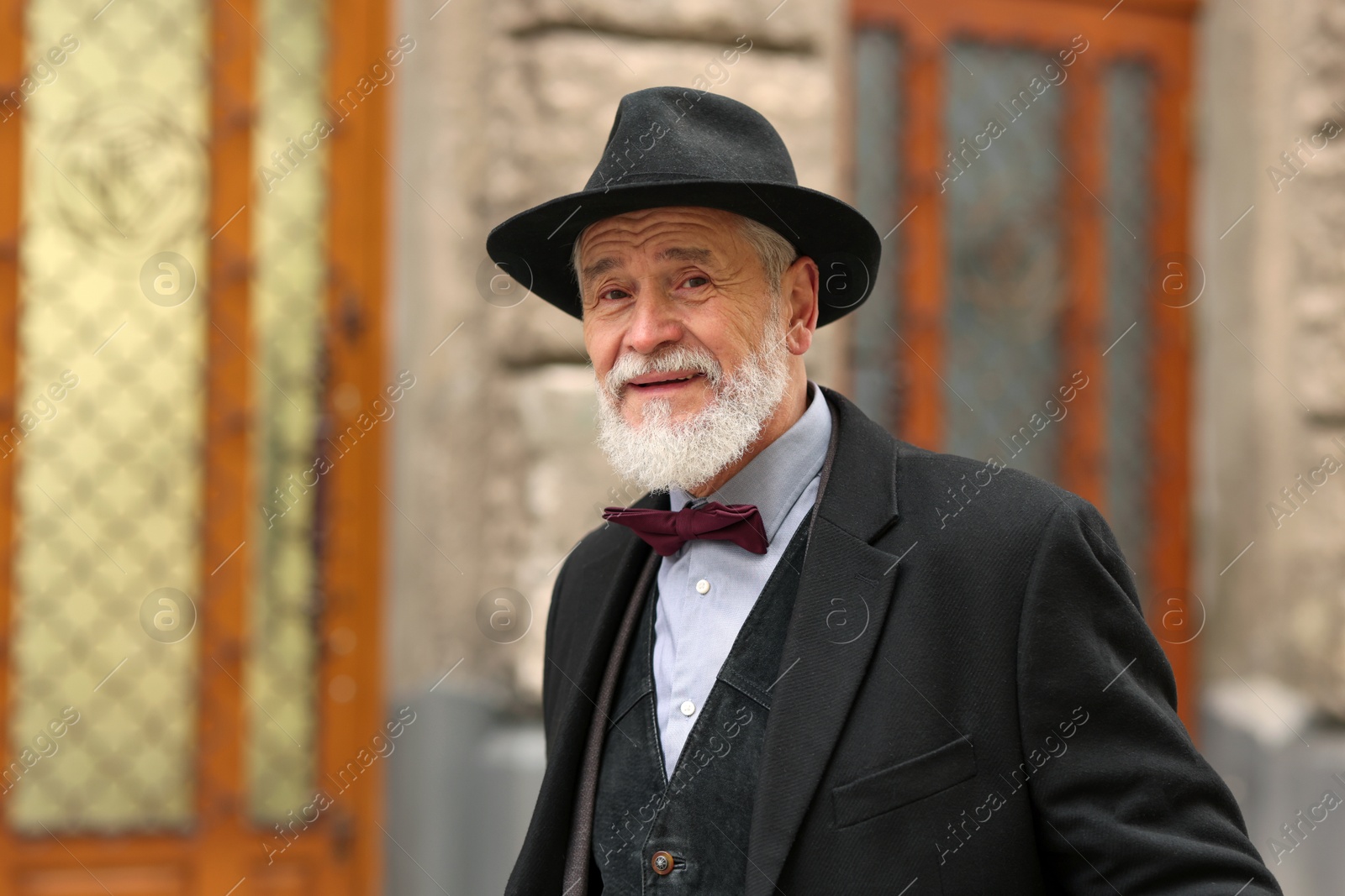 Photo of Bearded senior man in elegant outfit outdoors