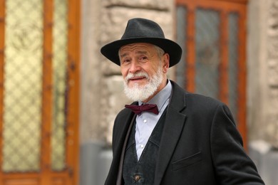 Photo of Bearded senior man in elegant outfit outdoors