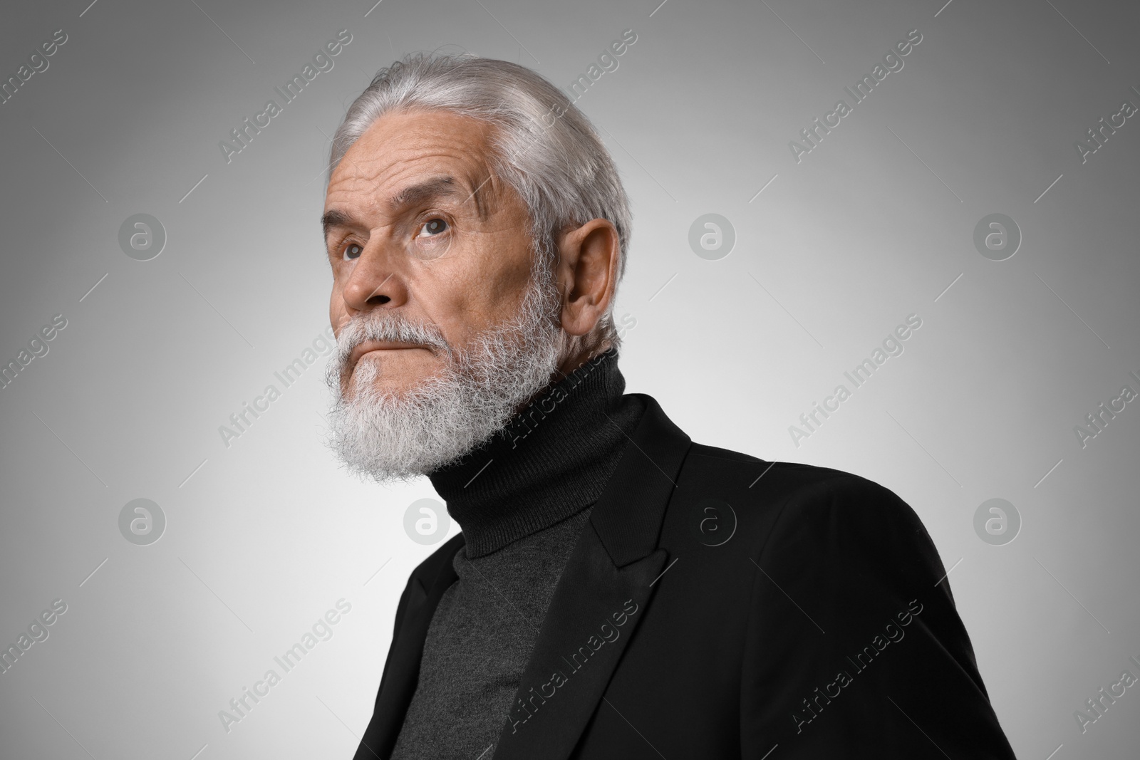 Photo of Portrait of confident senior man with silver beard on light grey background