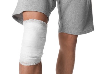 Photo of Man with medical bandage on his knee against white background, closeup