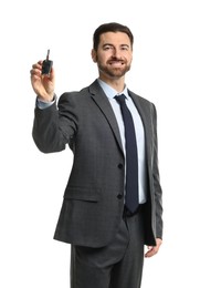 Photo of Cheerful salesman with car key on white background