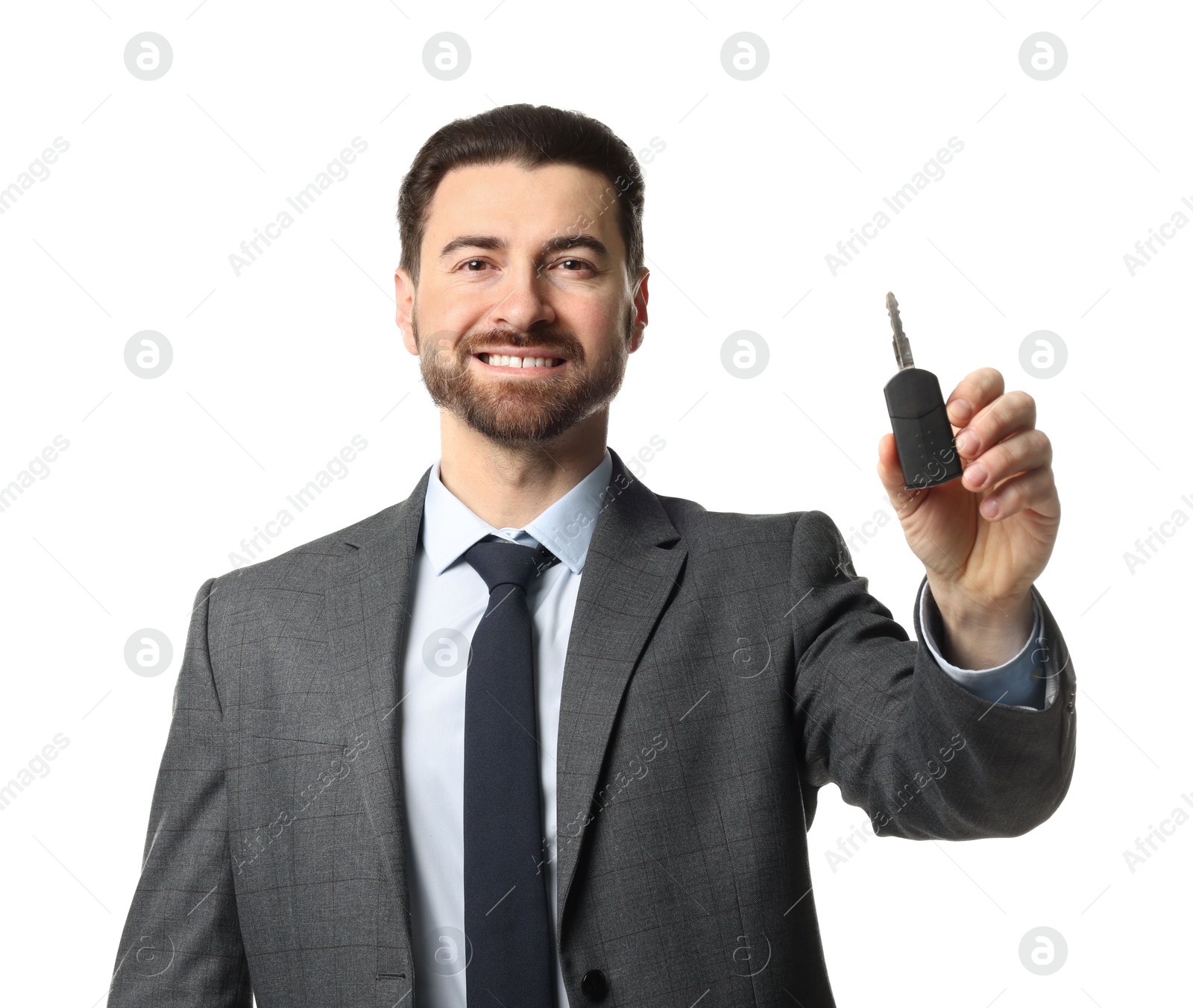 Photo of Cheerful salesman with car key on white background