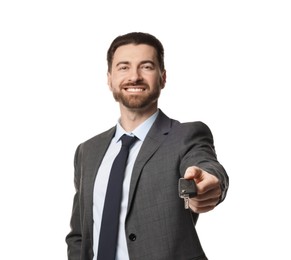 Photo of Cheerful salesman with car key on white background