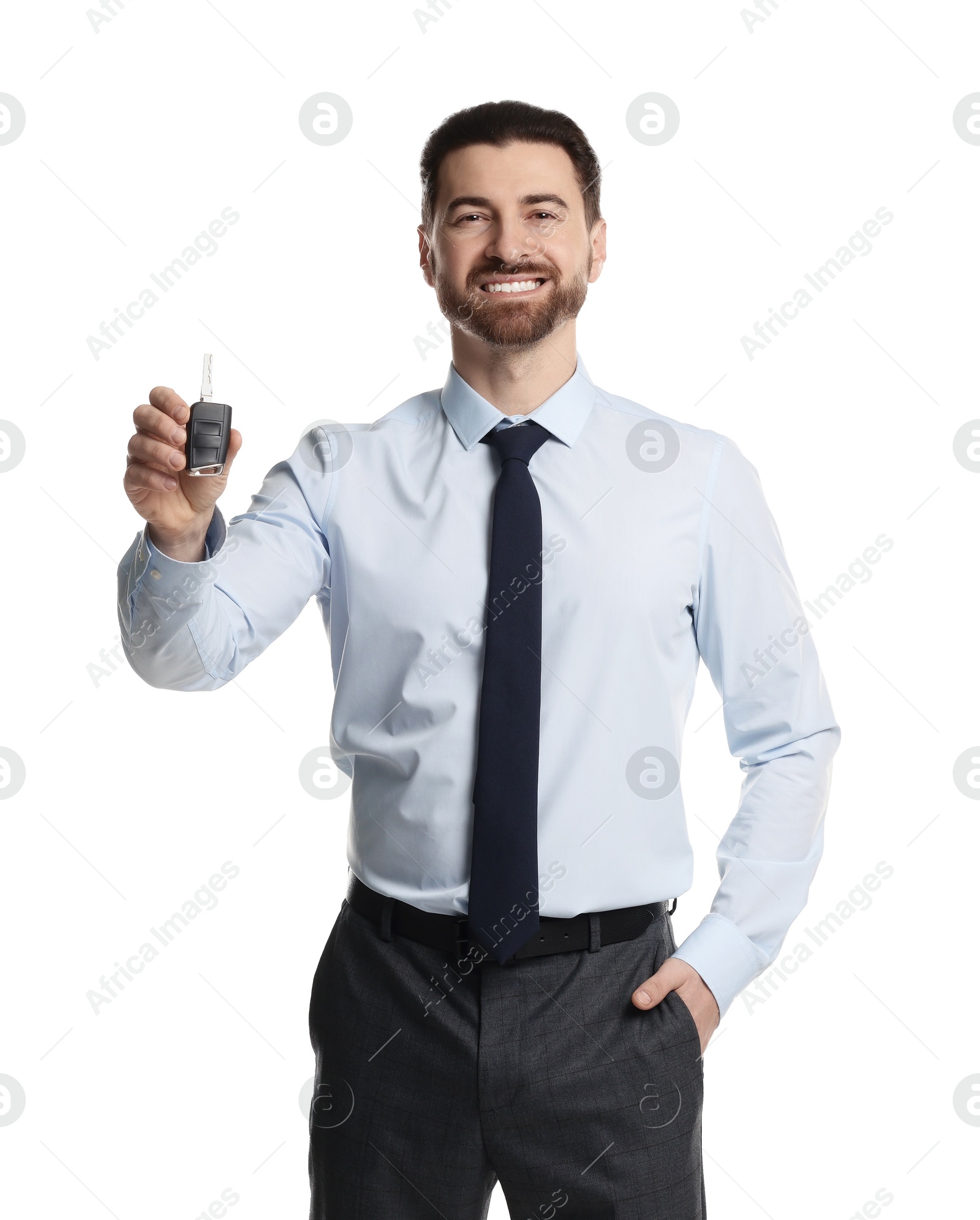 Photo of Cheerful salesman with car key on white background