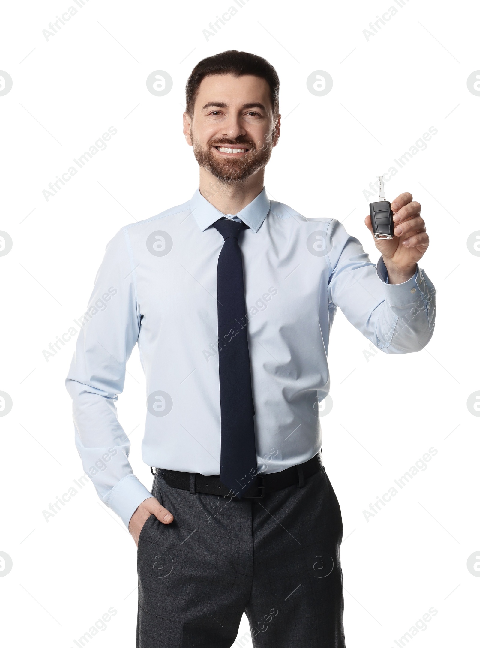 Photo of Cheerful salesman with car key on white background