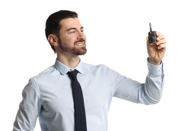 Photo of Cheerful salesman with car key on white background