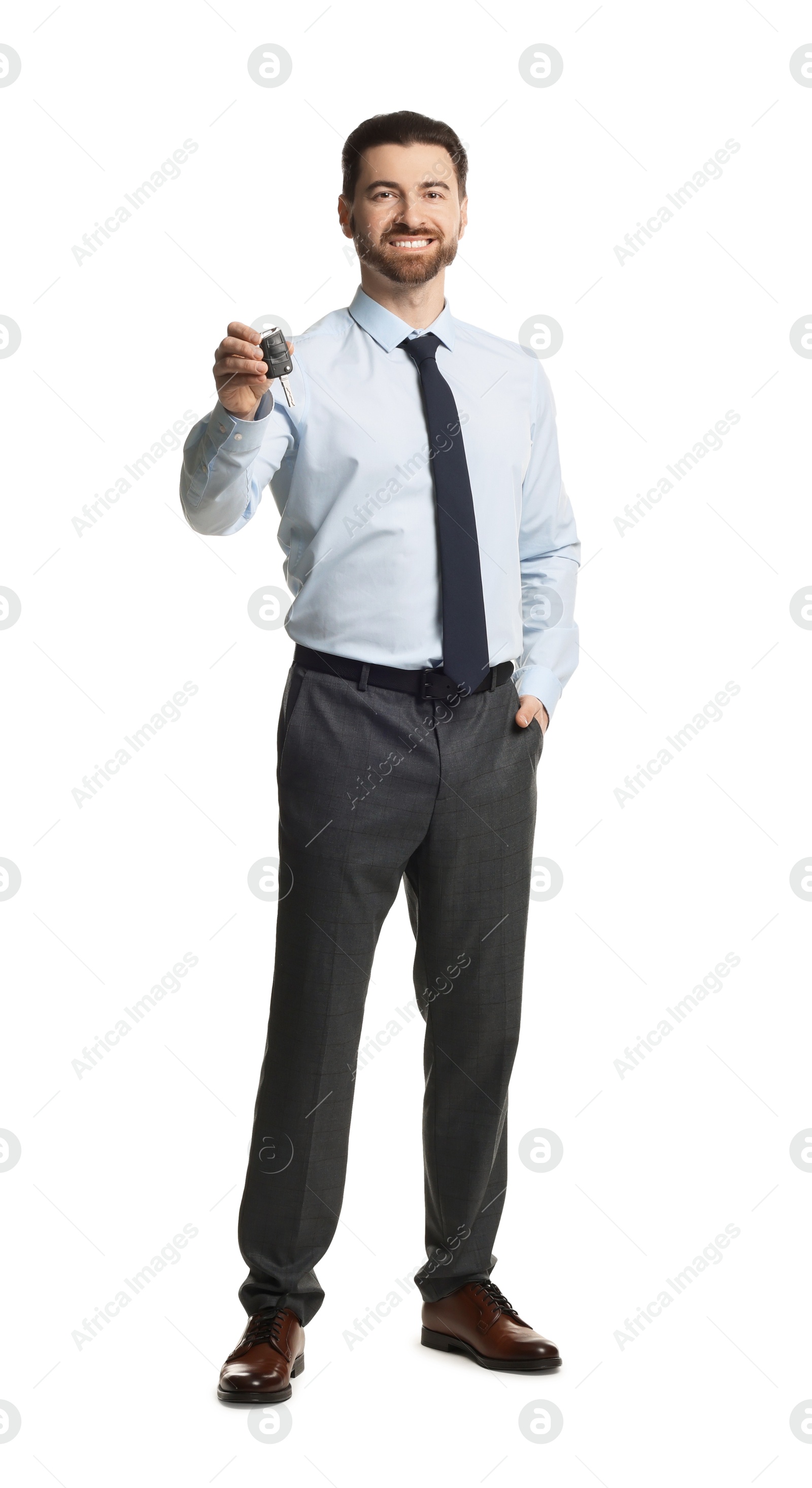 Photo of Cheerful salesman with car key on white background