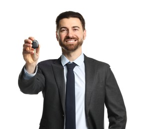 Photo of Cheerful salesman with car key on white background