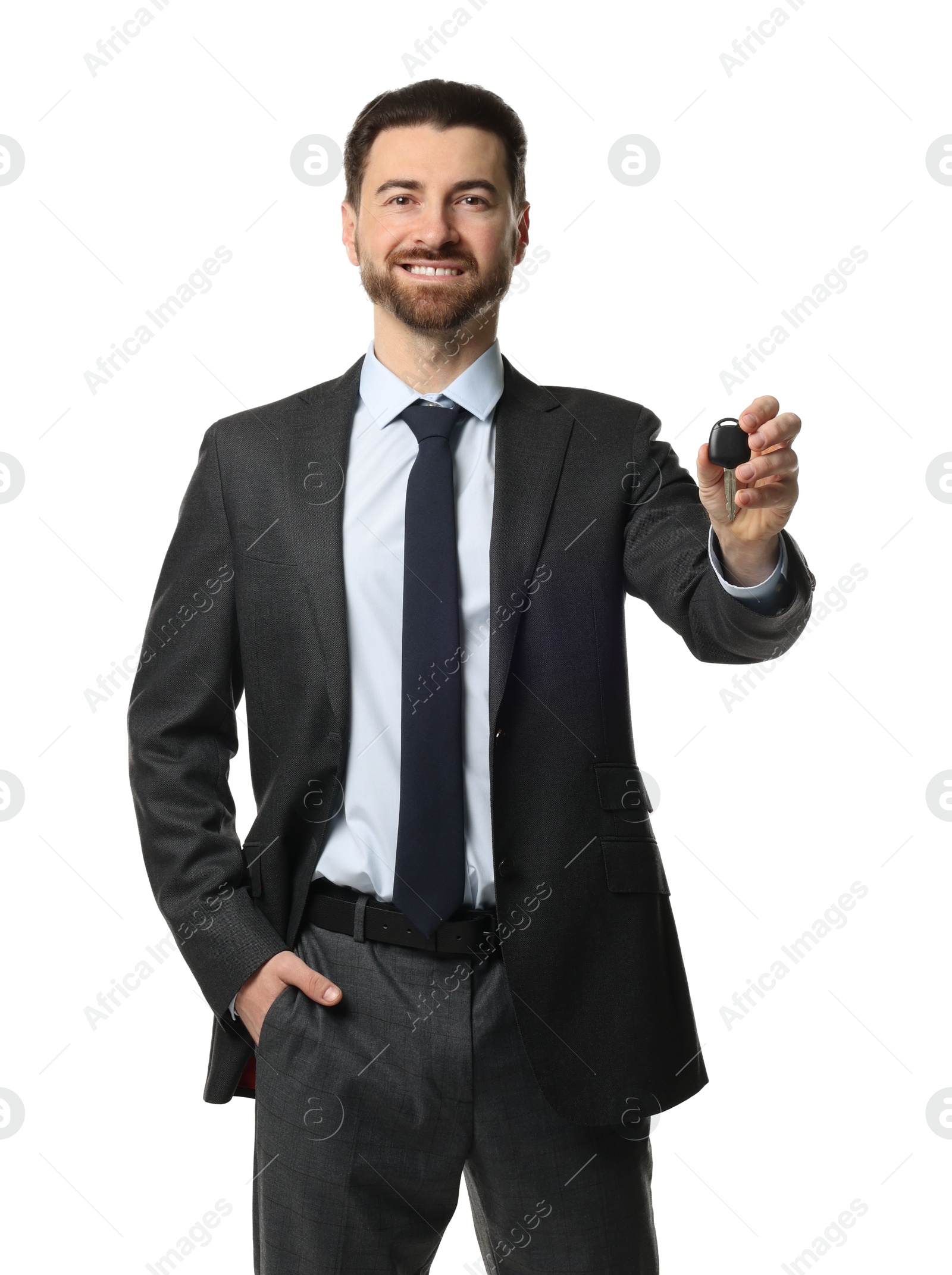 Photo of Cheerful salesman with car key on white background