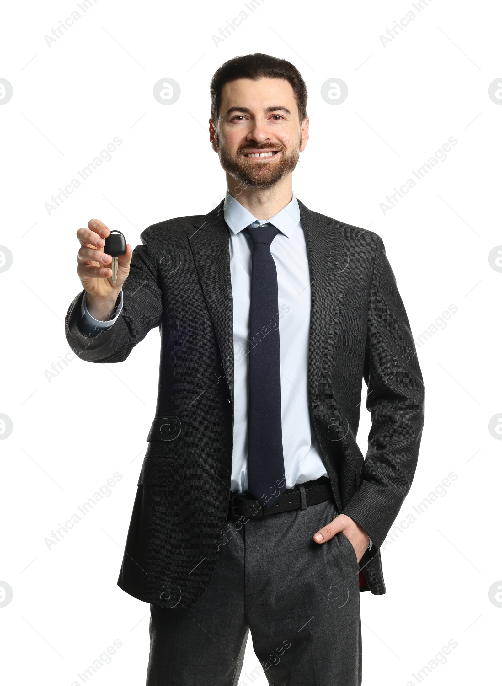 Photo of Cheerful salesman with car key on white background