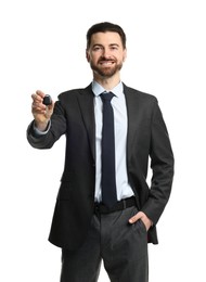 Photo of Cheerful salesman with car key on white background