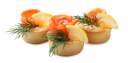 Photo of Tasty tartlets with salmon, lemon and dill isolated on white