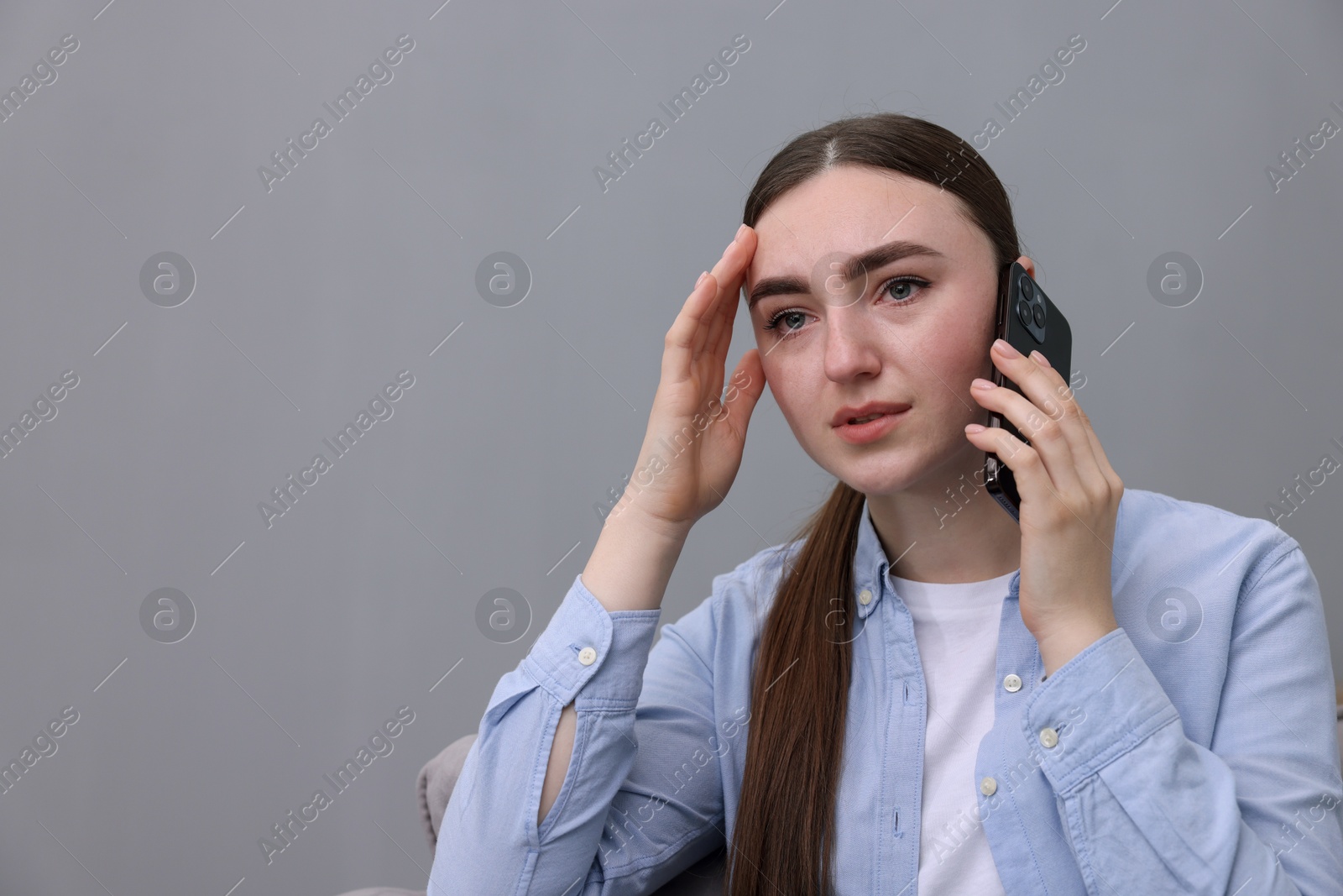 Photo of Stressed woman calling hotline for mental health help at home. Space for text