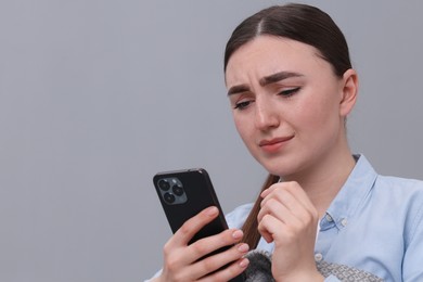 Photo of Depressed woman calling hotline for mental health help on sofa at home. Space for text