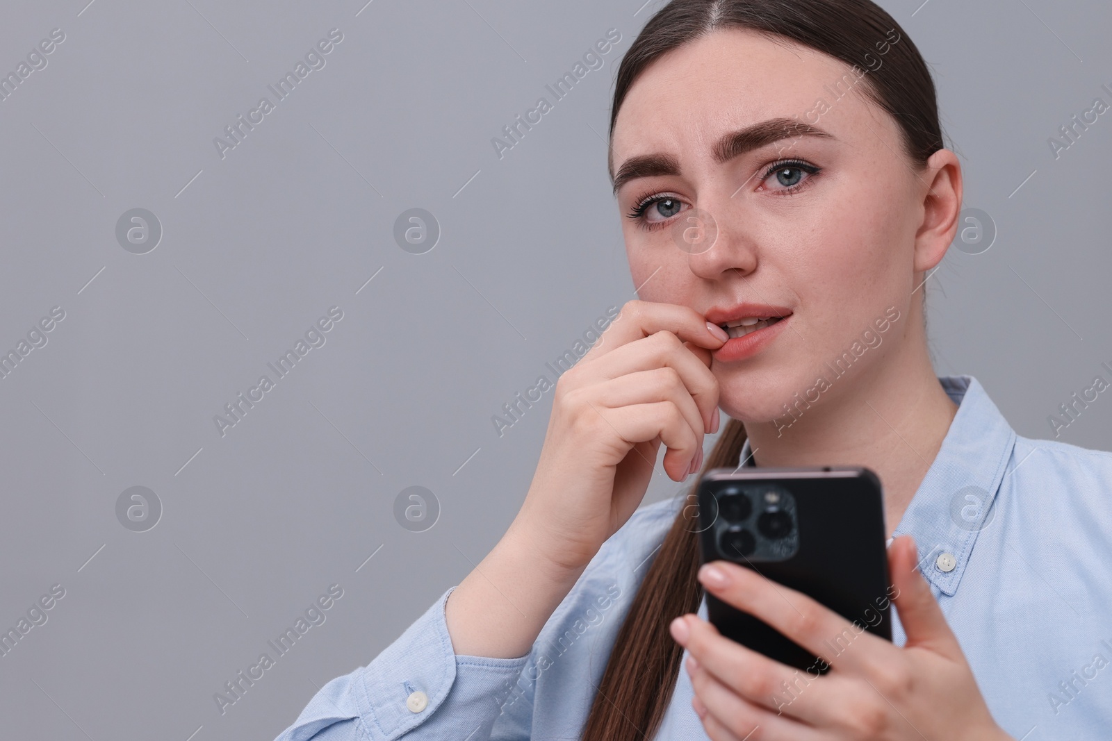 Photo of Depressed woman calling hotline for mental health help on sofa at home. Space for text