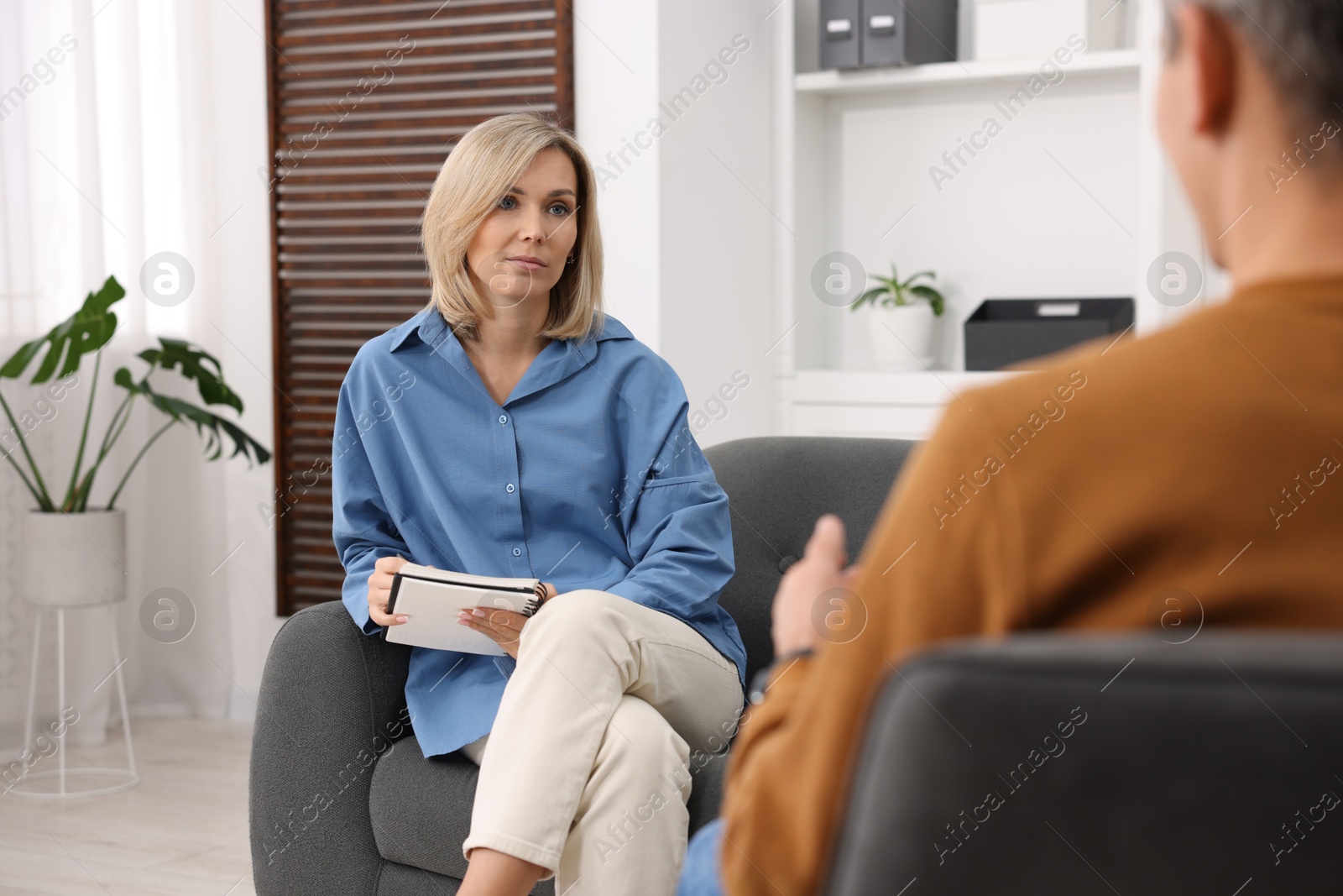 Photo of Professional psychologist working with patient in office